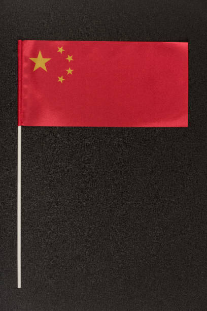 istock Table flag of China on black background. Red flag with stars. Vertical frame 1246488011