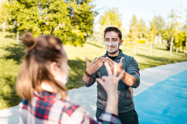 deaf and hard hearing young adults wearing special face mask for lip-reading - american sign language imagens e fotografias de stock