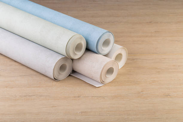 istock several rolls of multi-colored paper wallpaper on a wooden table 1246509352