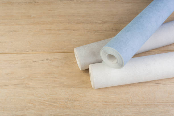 istock several rolls of multi-colored paper wallpaper on a wooden table 1246510458