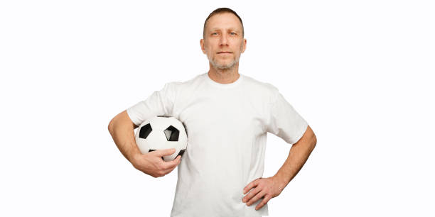 istock One man holds a soccer ball in akimbo posing 1246524944