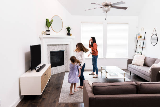 istock Mom and daughters play dancing video game 1246536637