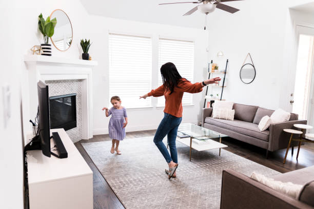 istock Mom and daughter dancing together 1246536642