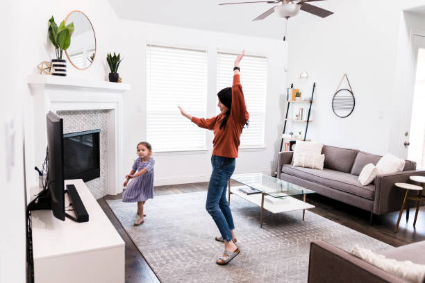 istock Mom and daughter dancing together 1246537725