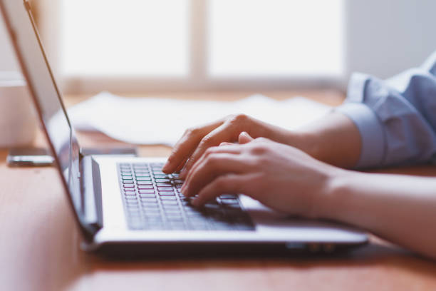 istock Woman working at home office hand on keyboard close up 1246543554