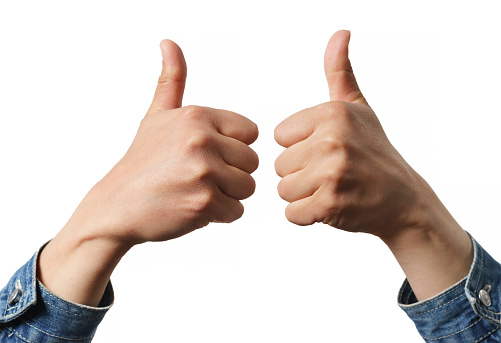 Woman holding two thumbs up into the air isolated on white