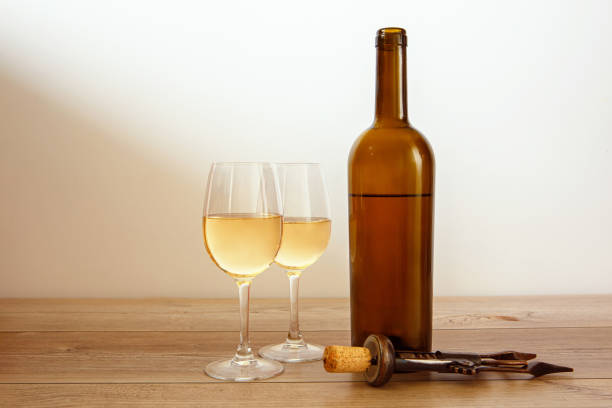 Glass bottle of wine and two filled glasses stock photo