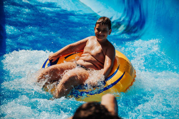 istock Happy boy having fun in water park 1246548427
