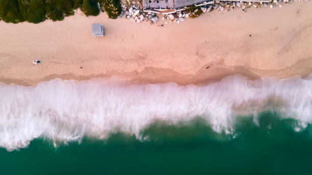 istock 4K Drone Aerial Beach Sunset waves Bird Eye view 1246559975