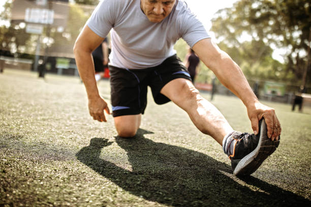 istock Mid-adult men stretching before soccer game 1246564439