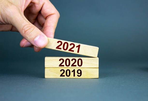 istock A male hand stacks wooden blocks with numbers 2019, 2020, 2021. 1246566025
