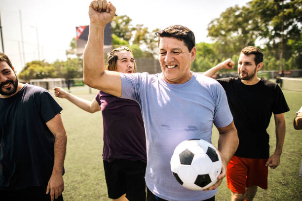 istock Mixed age range group of men celebrating success on soccer field 1246568132