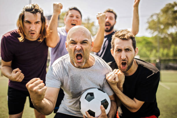 istock Mixed age range group of men celebrating success on soccer field 1246573130