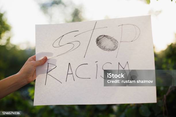 Woman Holding White Paper With Text Stop Racism Stock Photo - Download Image Now - Anti-racism, Racism, Cardboard
