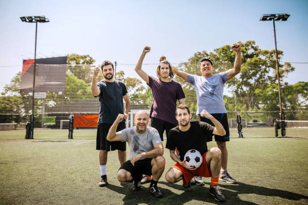 istock Mixed age range men soccer team celebrating success 1246574121