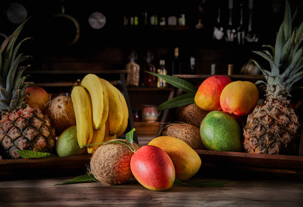 istock Wooden crates with assorted tropical fruits in rustic kitchen. Natural lighting 1246592499