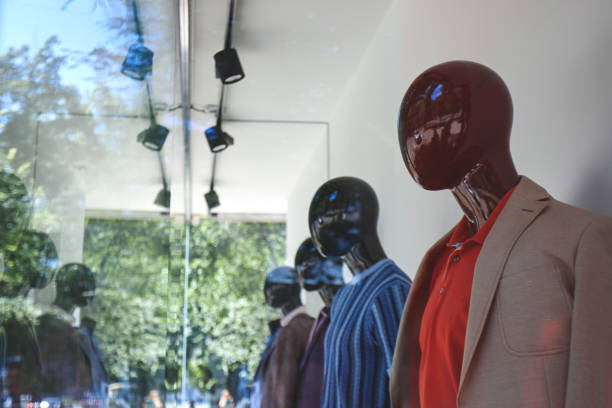 istock open or closed commercial clothes store. copy space for design. retail garment shop. display case with mannequins. 1246600713