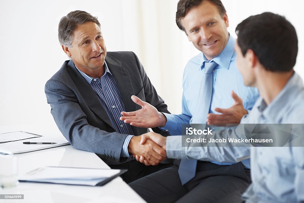 Business partners Mature business man shaking hands with his colleague during meeting 40-49 Years Stock Photo