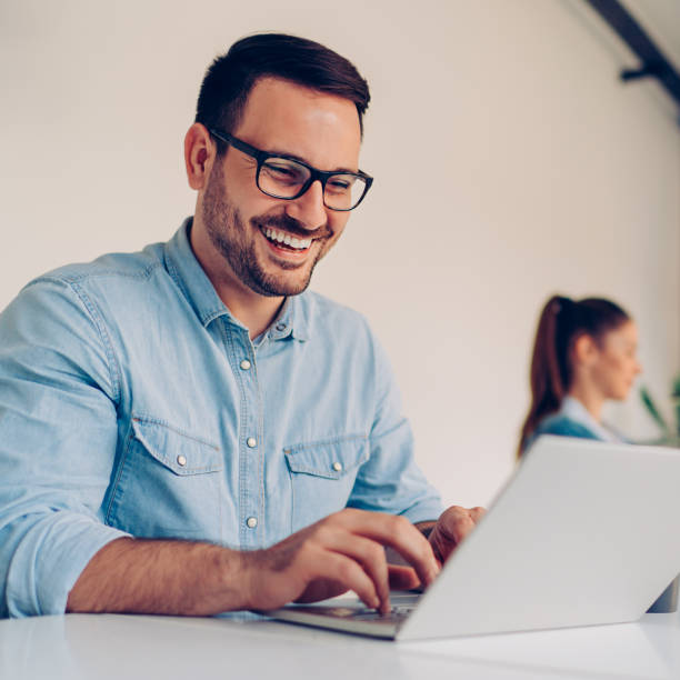 istock Young businessman using laptop with a smile on his face 1246616885
