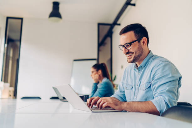 istock Happy businessman using laptop in the conference room 1246616919