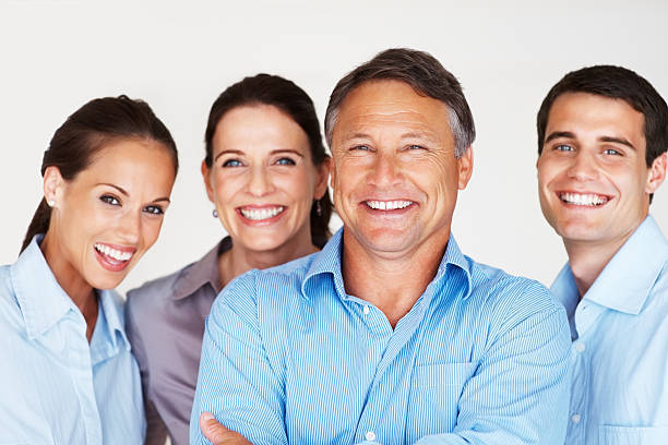 Four young elegance smiling people. Full length studio shot isolated on white.