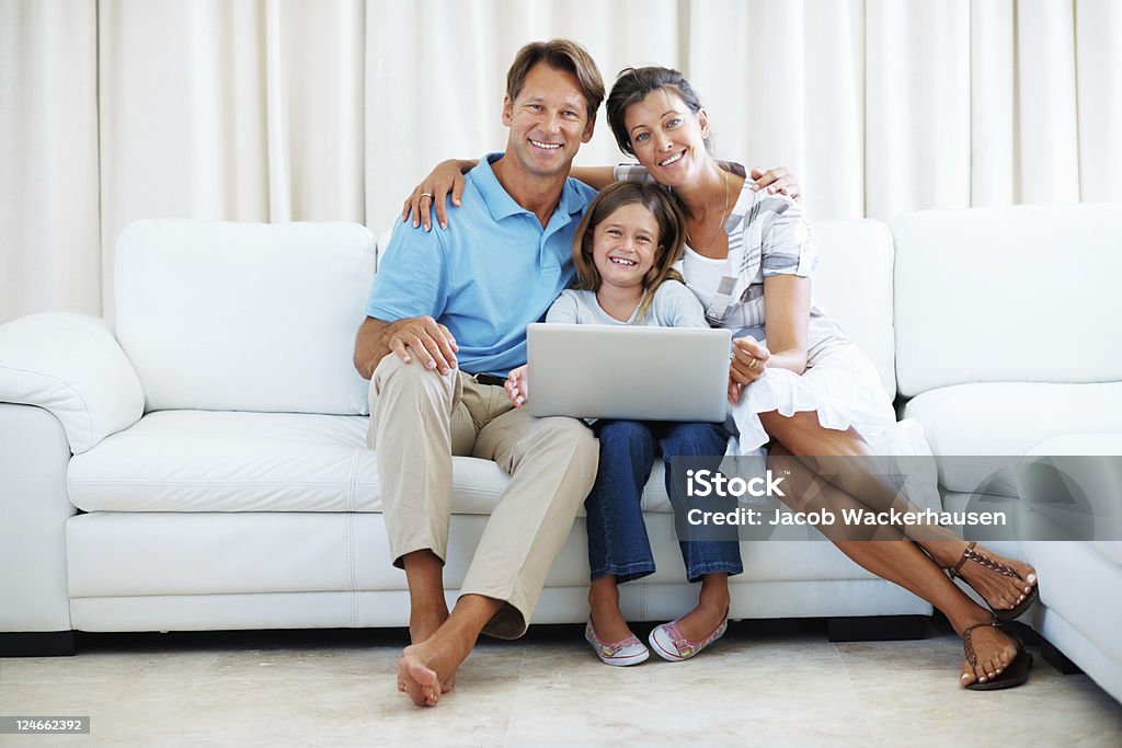 Familia de tres usando computadora portátil - Foto de stock de 40-49 años libre de derechos