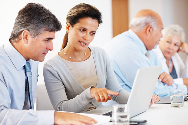 istock Business associates working on a project using laptop 124663867