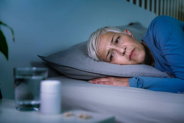 istock Insomnia and sleeping pills that do not work. Mature woman with sleeping problems awake in the middle of the night 1246651021