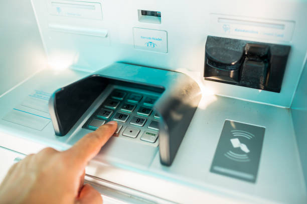 istock Selective focus to ATM keypad with blur finger press on it. Finger about to press a pin code on a pad. 1246664231