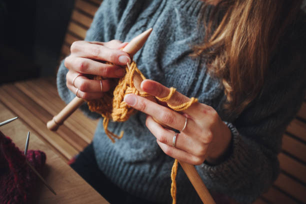 istock Close up on woman's hands knitting 1246689042