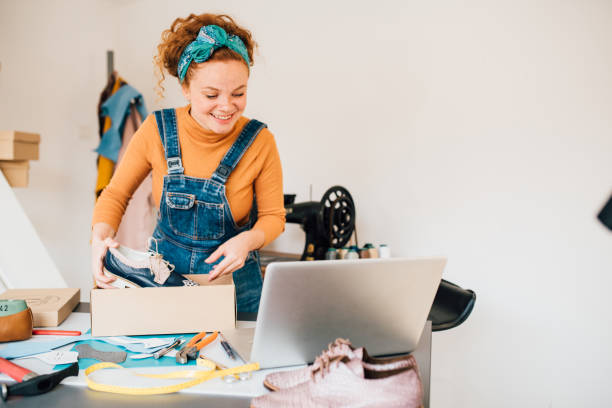 istock Young woman packing and selling leather shoes 1246689049