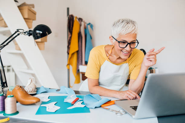istock Mature shoemaker working on the new shoes design 1246689058