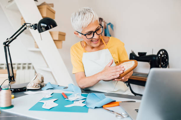 istock Mature shoemaker working on her handmade products 1246689060