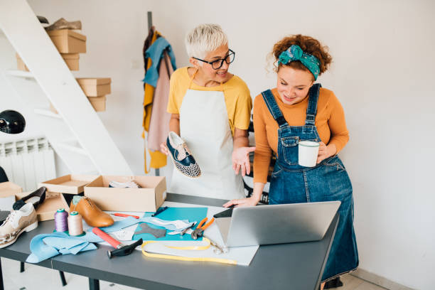 istock Two happy shoemakers working together 1246689072