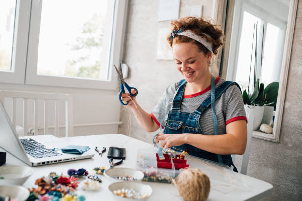 istock Young woman watching tutorials of how to make jewelry 1246689090
