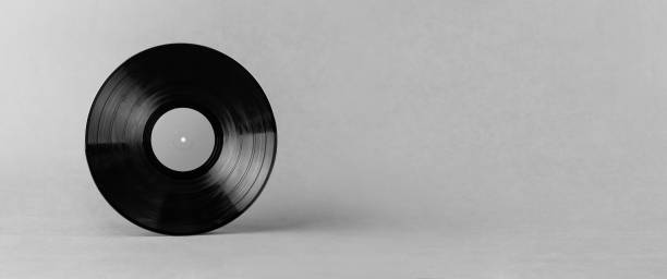 istock Black LP vinyl record isolated on abstract gray background with wide copy space 1246689399