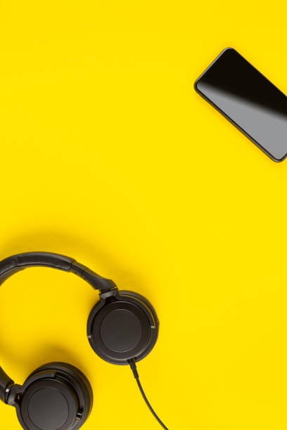 istock Creative music application minimal concept with headphones and smartphone on colorful background 1246689719