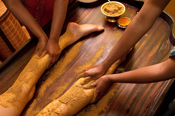 A traditional Indian Ayurvedic oil foot massage indian doctors doing traditional ayurvedic oil foot massage ayurveda stock pictures, royalty-free photos & images