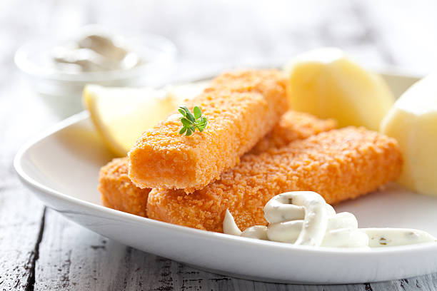 fish fingers with potatoes fresh fish fingers with potatoes and remoulade sauce fish stick stock pictures, royalty-free photos & images