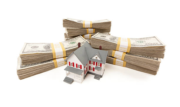istock Small House with Stacks of Hundred Dollar Bills 124671804