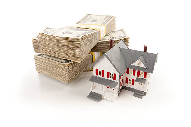 istock Small House with Stacks of Hundred Dollar Bills 124671872