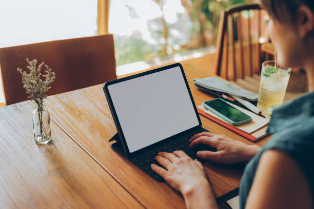 istock Young Freelance Businesswoman Working on her Tablet Computer at a Cafe 1246728966