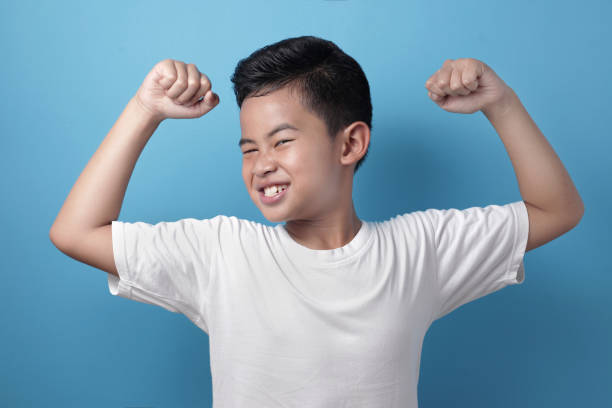 istock Strong healthy Asian boy shows his muscle 1246739244