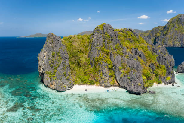istock Aerial drone view of a tiny tropical island with beach, coral reef and sharp limestone cliffs. Shimizu Island, El Nido, Palawan 1246744882