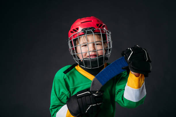 istock A happy five year old boy is posing in studio with his hockey equipment. 1246754616