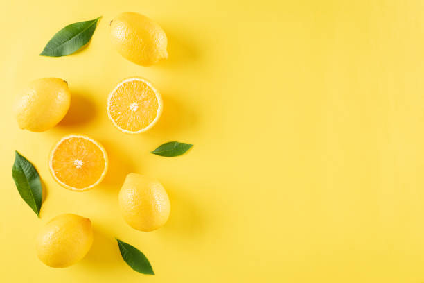 istock Summer composition made from oranges, lemon and green leaves on pastel yellow background. Fruit minimal concept. Flat lay, top view, copy space. 1246793650