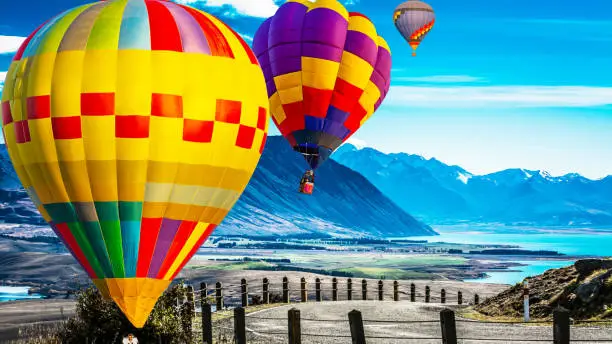 Beautiful colors of the hot air balloons flying over on the hill at new zealand