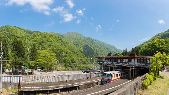 Tateyama - May 10: Tateyama station in Toyama city is interchange tram or tramcar to the japan alps with mountain and blue sky background on May 10, 2015 in Tateyama, Japan