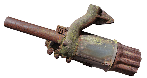 The exhaust pipe of an old rusty vintage tractor looks like a laser blaster. Isolated on white