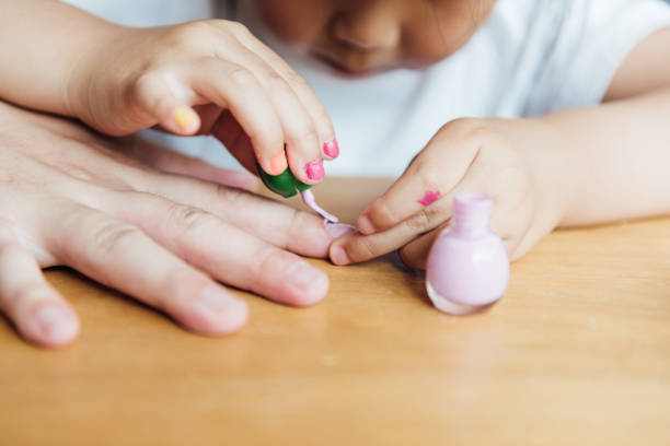 istock Asian father and daughter are applying nail polish 1246864470